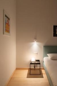 a bedroom with a bed and a table with a lamp at Hotel 171 in Rotterdam