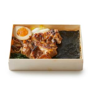 a box filled with meat and vegetables on top of a table at TSUKI Tokyo in Tokyo