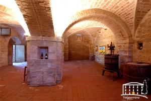 a large room with a large room with a wine cellar at Relais Valguerriera in Apecchio
