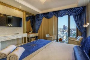 a bedroom with a large bed and a large window at Leslion Luxury Hotel in Antalya +69 photos