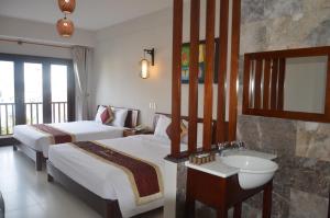 Postel nebo postele na pokoji v ubytování Sunshine Hoian Hotel