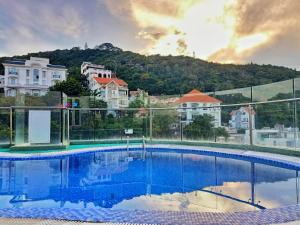 a swimming pool with a mountain in the background at BH Residence Inn Hotel & Apartment in Vung Tau