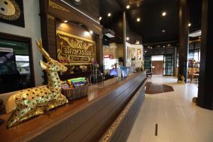 a shop with a statue of a deer on a counter at Luckswan Resort Chiang Rai - SHA Extra Plus in Chiang Rai