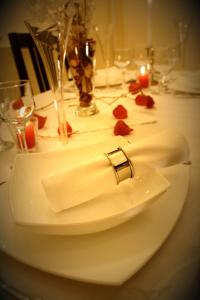 a white table with a napkin and a ring on it at Hotel Tivoli in Sovata