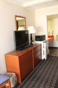 a television on a dresser in a hotel room at Motel Reedsburg in Reedsburg