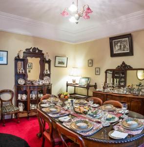 a dining room with a table with dishes on it at Moate Lodge in Athy