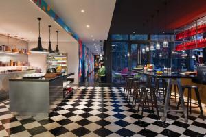 a restaurant with a checkered floor and a bar at YaTi by Artyzen Hongqiao Shanghai - Korean Street in Shanghai