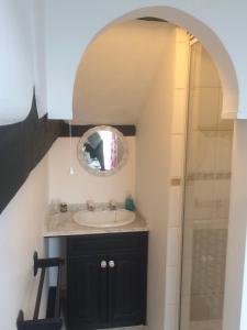 a bathroom with a sink and a mirror at 1 The Mews Cottages in Ledbury