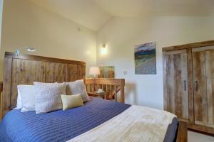 a bedroom with a bed with a blue comforter at 201C Mountain Side 1BR 1BA condo in Frisco +20 photos