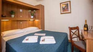 Postel nebo postele na pokoji v ubytování Hotel Trastevere