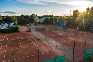 a tennis court with two tennis courts at Tennis Golf Hotel Höllrigl in Kottingbrunn
