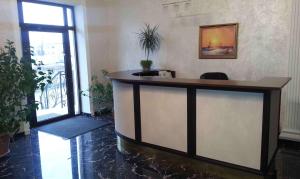 a lobby with a reception desk in a building at VLG Hotel in Boryspilʼ