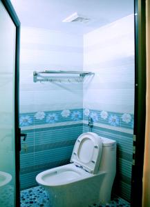 a bathroom with a toilet with the lid up at The Mountain View Homestay in Ninh Binh