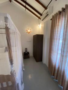 Postel nebo postele na pokoji v ubytování Kanada House Unawatuna
