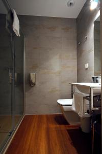 a bathroom with a shower and a sink and a toilet at Pensión Iturriza in Donostia-San Sebastián