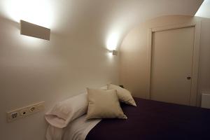 a bedroom with a bed with two pillows on it at Pensión Iturriza in Donostia-San Sebastián