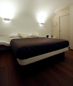 a bedroom with a large bed with two pillows at Pensión Iturriza in Donostia-San Sebastián