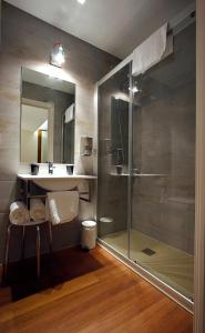 a bathroom with a glass shower and a sink at Pensión Iturriza in Donostia-San Sebastián