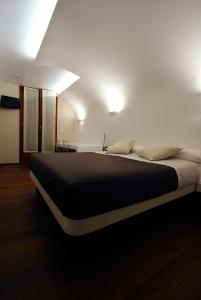 a bedroom with a large bed in a room at Pensión Iturriza in Donostia-San Sebastián