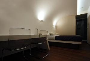 a bedroom with a bed and a glass table and chairs at Pensión Iturriza in Donostia-San Sebastián