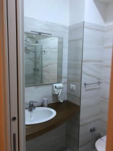 a bathroom with a sink and a mirror at Le Affacciate Bruzie Home Guest House in Cosenza