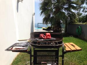 a grill with two hot dogs on top of it at Sea House Madeira in Garajau