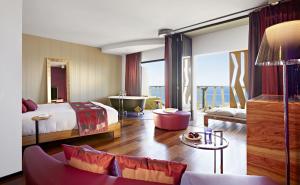 A bed or beds in a room at Bohemia Suites & Spa - Adults Only