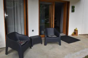 a group of chairs sitting in front of a door at VAUJANYLOCATIONS - Domaine du Pâtre in Vaujany