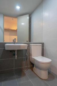 a bathroom with a toilet and a sink at PINTARMAN SUITES @ MIRI TIMES SQUARE in Miri