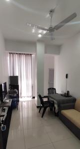 a living room with a couch and a table at SkyCasa Holiday Apartments in Mount Lavinia