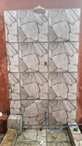 a stone wall with a hose hooked up to it at Casa com ar condicionado e 2 suítes ilha comprida in Ilha Comprida +20 photos