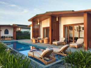 a villa with a swimming pool and a resort at Mövenpick Resort Cam Ranh in Cam Ranh