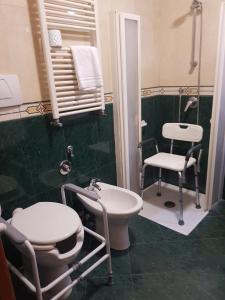 a bathroom with a sink and a toilet and a chair at Hotel Mirage in Rome