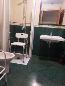 a bathroom with a sink and a chair in it at Hotel Mirage in Rome