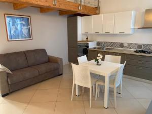 a kitchen and living room with a table and a couch at Hotel Soleluna in Piano di Sorrento