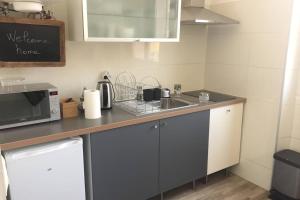 a kitchen with a sink and a microwave at Appartement Hyper Centre-Vieux Port-Place aux Huiles in Marseille