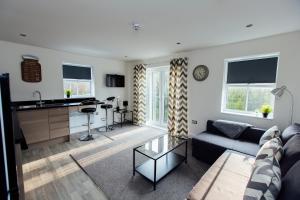a living room with a couch and a table at 1 2 Bedroom Shield House Apartments Sheffield Centre in Sheffield