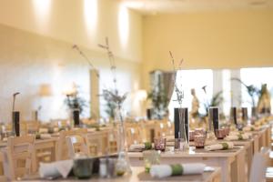a long row of tables in a room with chairs at Mjus Resort & Thermal Park in Körmend +160 photos