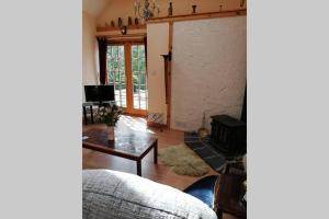 a living room with a couch and a table at Boghead Cottage: Holiday Cottage in Royal Deeside in Banchory