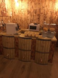 a kitchen with a counter with a microwave on it at chambre d'hôte medieval du vieux bourg in Chailloué