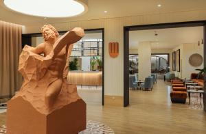 a statue of a woman dancing in a lobby at H10 Imperial Tarraco 4 Sup in Tarragona