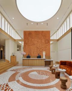a lobby with a large rug on the floor at H10 Imperial Tarraco 4 Sup in Tarragona