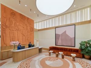 a lobby with a couch and a large screen at H10 Imperial Tarraco 4 Sup in Tarragona