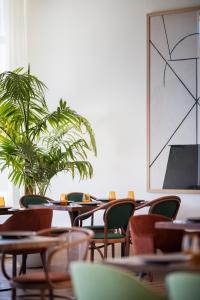 a room with tables and chairs and a plant at H10 Imperial Tarraco 4 Sup in Tarragona