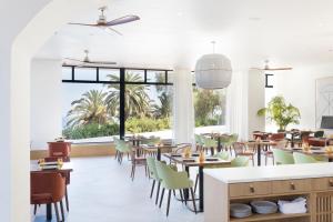 a restaurant with tables and chairs and a large window at H10 Imperial Tarraco 4 Sup in Tarragona