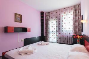 a bedroom with two towels on a bed at 1-st Line Izvora Sea View Apartments on Golden Sands in Golden Sands