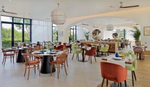 a restaurant with tables and chairs and windows at H10 Imperial Tarraco 4 Sup in Tarragona