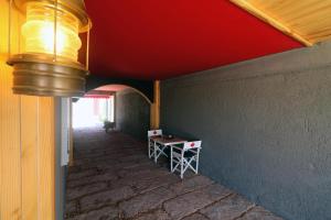 a room with a table and a red ceiling at Old Farm Hotel in Izmir
