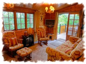 a living room with a couch and chairs and a television at Blelham Tarn (Log Cabin) in Ambleside