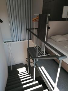 a staircase in a room with a bed and a chair at Green Villas Douro in Gondomar